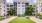a building with a lawn and trees