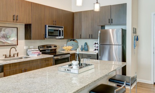 a kitchen with a marble island