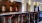 a bar with stools and chandeliers
