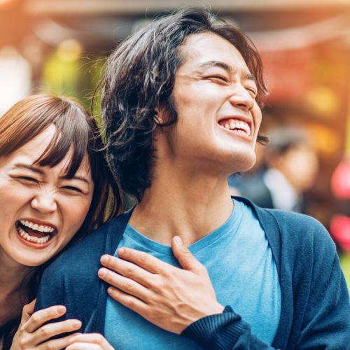 a couple laughing in the streets