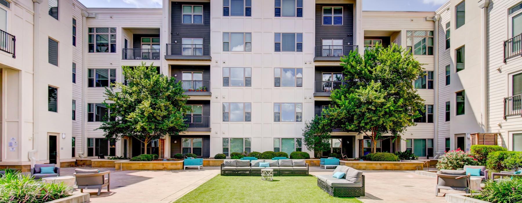 a building with a lawn and trees